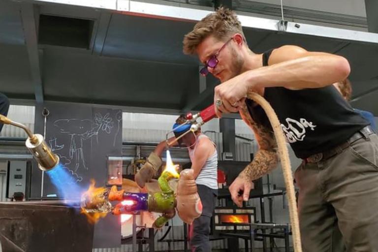 Danny White using a torch in the glassblowing studio